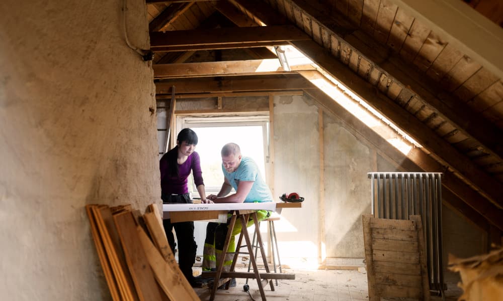 Two people working on home renovation