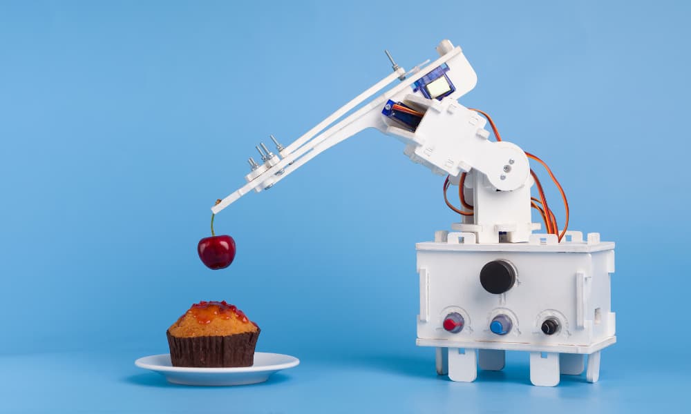 A robot helping to assemble a dessert