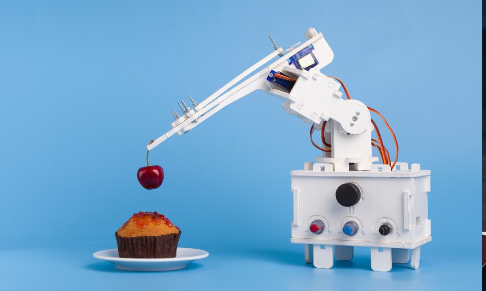 A robot helping to assemble a dessert