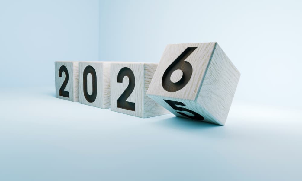 Light gray wooden blocks changing from 2025 to 2026 against a light blue background.